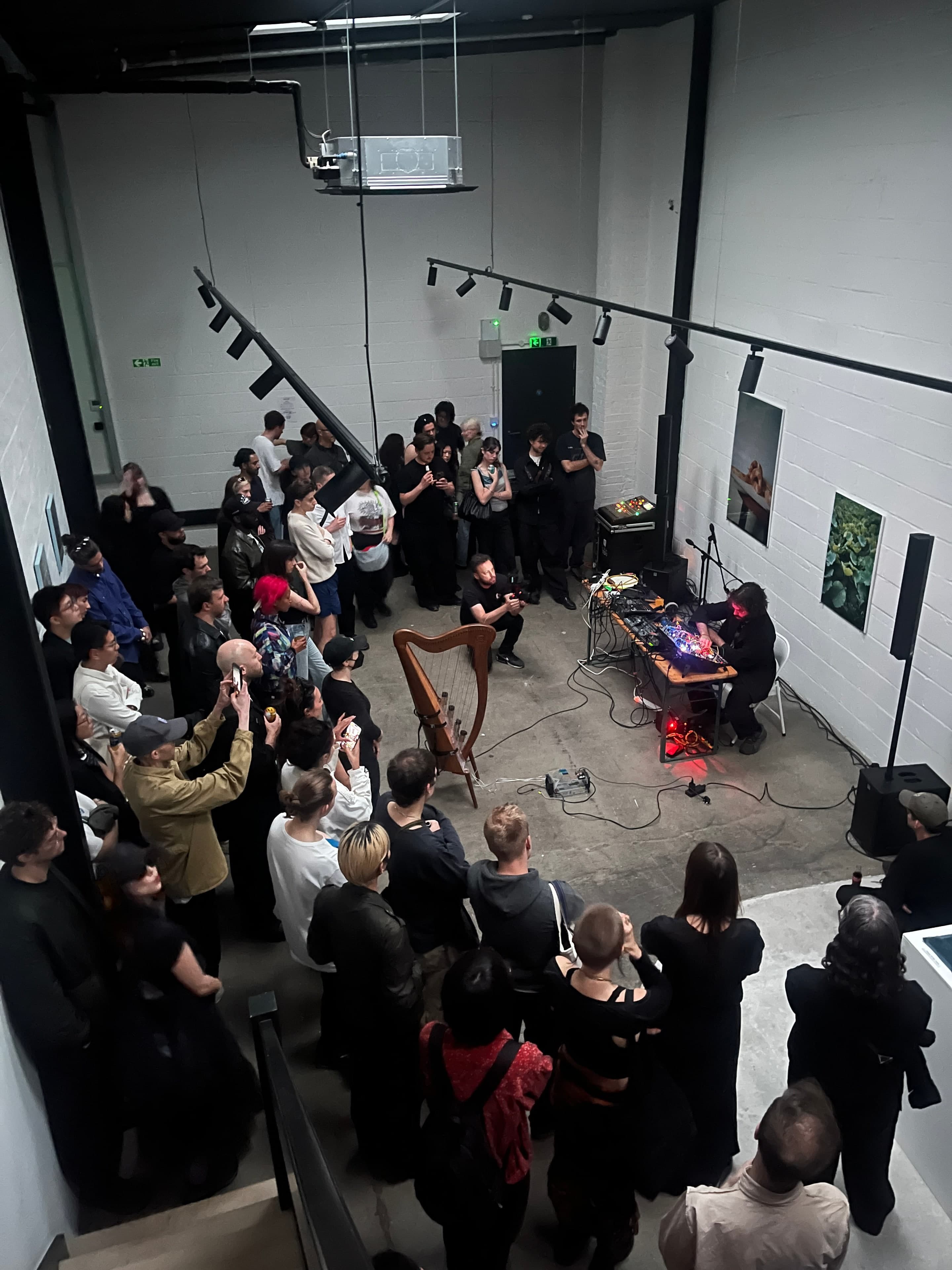 Audience gathered around a live performance with harp and modular synths at Standalone.
